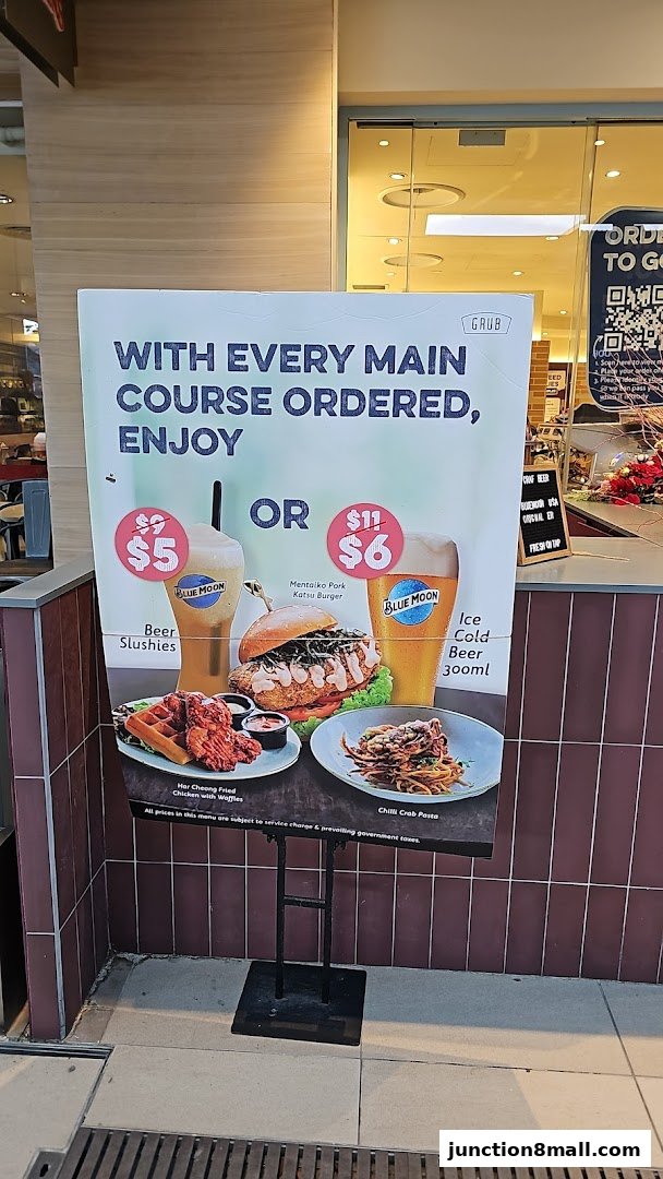 A promotional sign for GRUB Junction 8 offering deals on beer slushies and ice cold beer with main course orders.