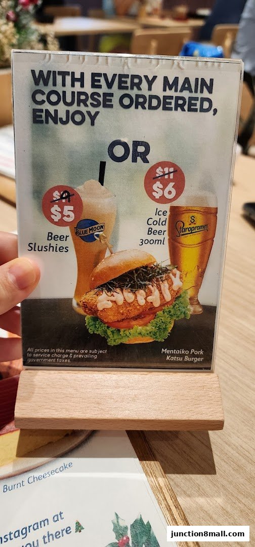A menu offering a special deal on beer slushes or ice cold beer with any main course order.