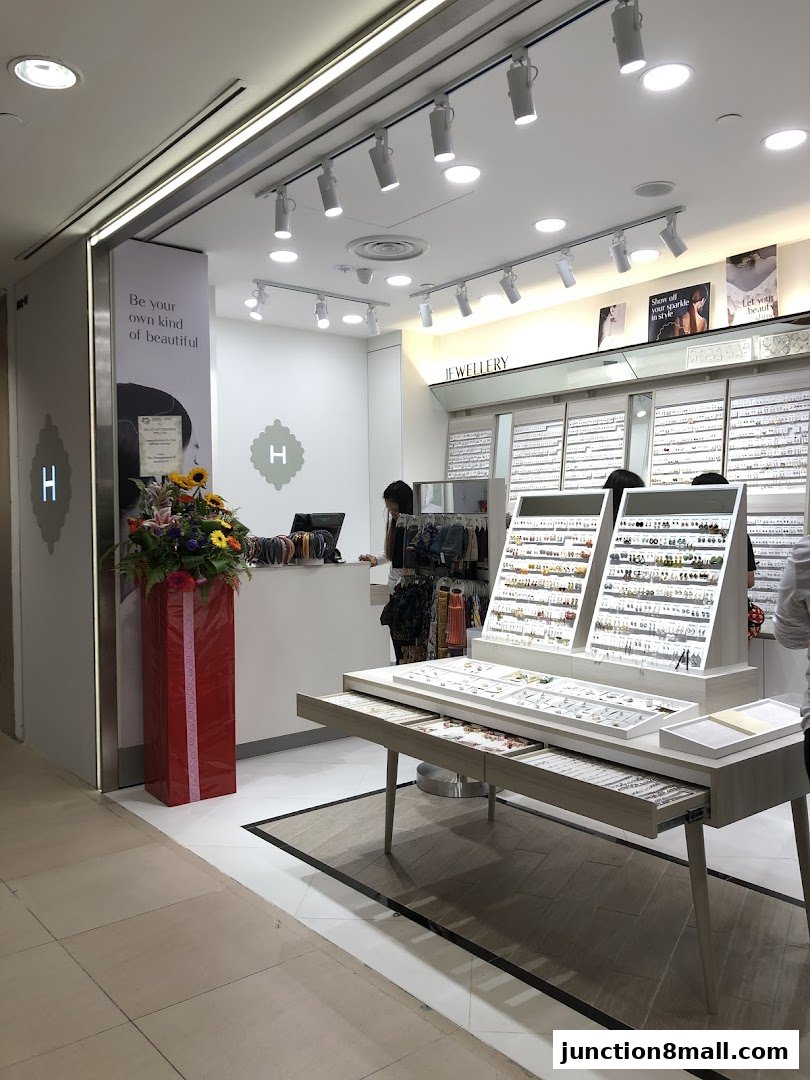A well-lit jewelry store interior with displays of earrings, necklaces, and other accessories.
