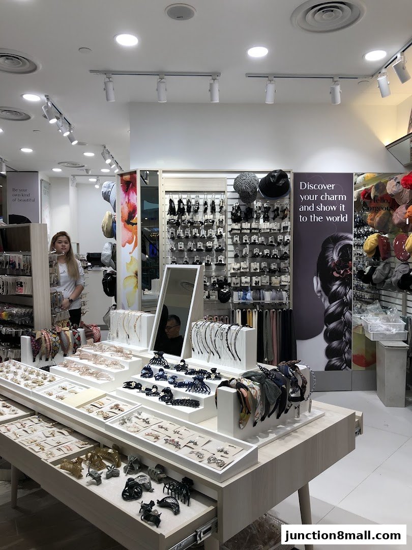 A well-lit shop interior showcasing a wide variety of hair accessories and headbands.