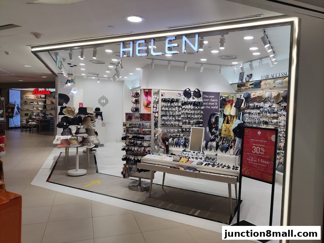 The exterior of a retail shop named Helen, displaying various hair accessories and hats.