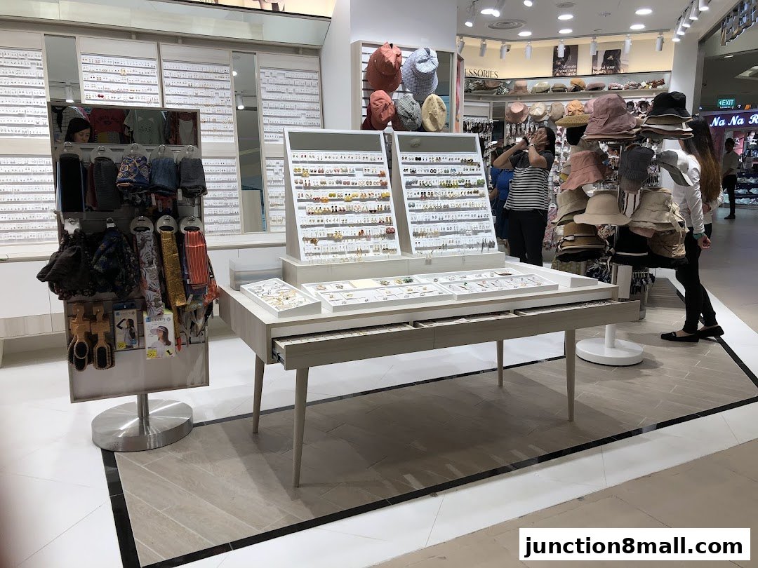 A retail shop displaying a variety of accessories including earrings, scarves, and hats.
