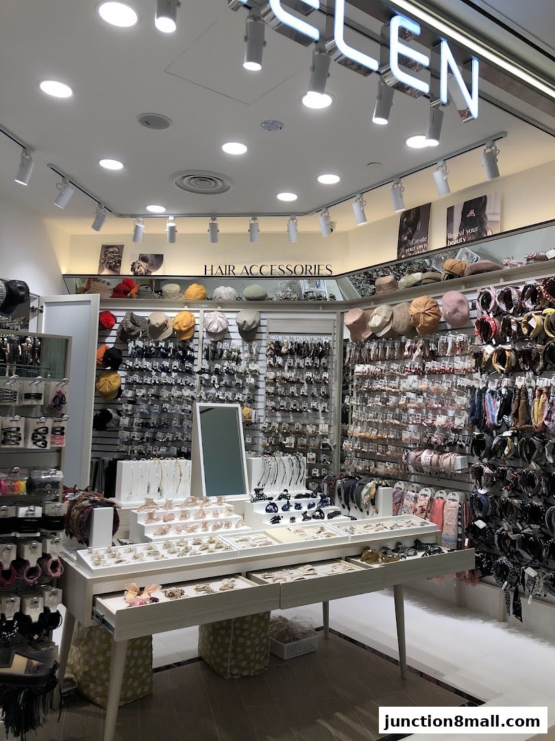 A well-lit shop interior showcasing a wide variety of hair accessories and headwear.