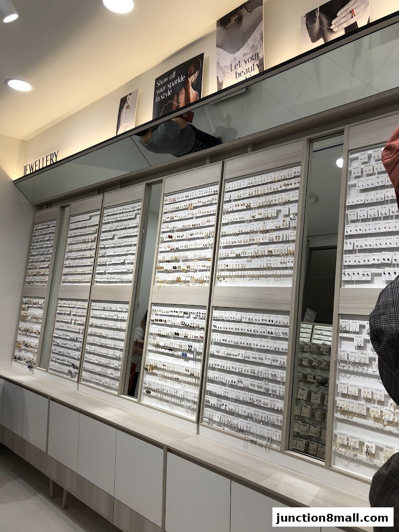 A wide display of earrings and jewelry in a well-lit retail store.