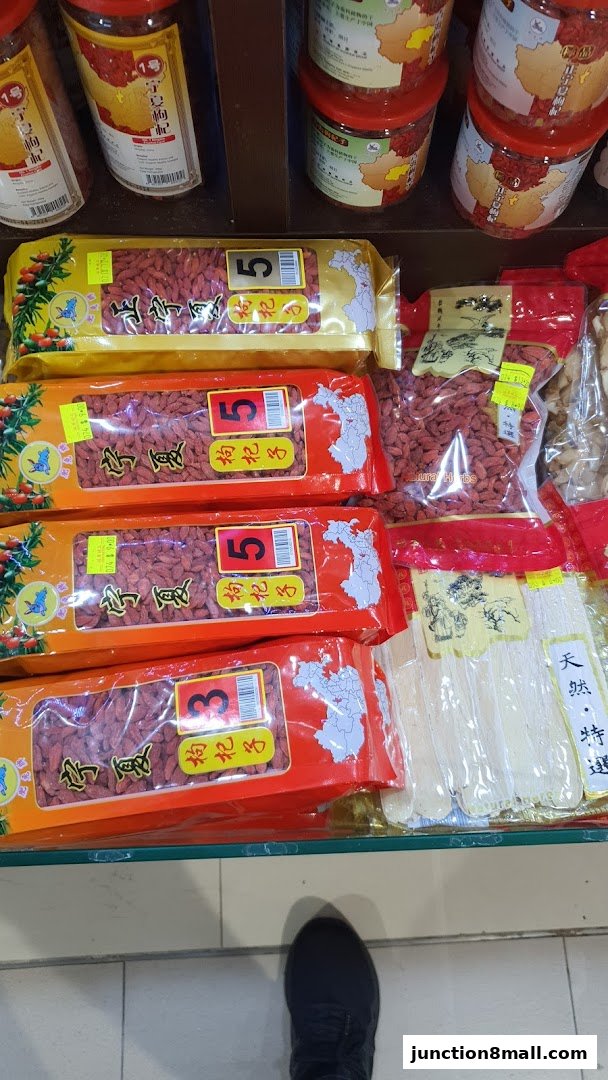 Packaged goji berries and other dried goods displayed on shelves in a retail store.