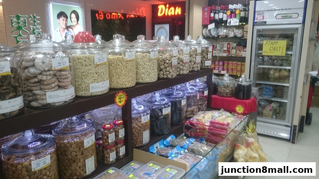 A retail shop interior displaying various dried goods, nuts, and snacks in glass jars and packaging.
