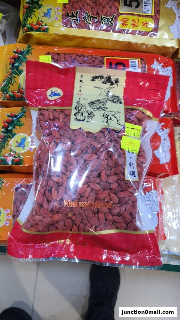Bags of goji berries and other natural herbs displayed in a retail shop.