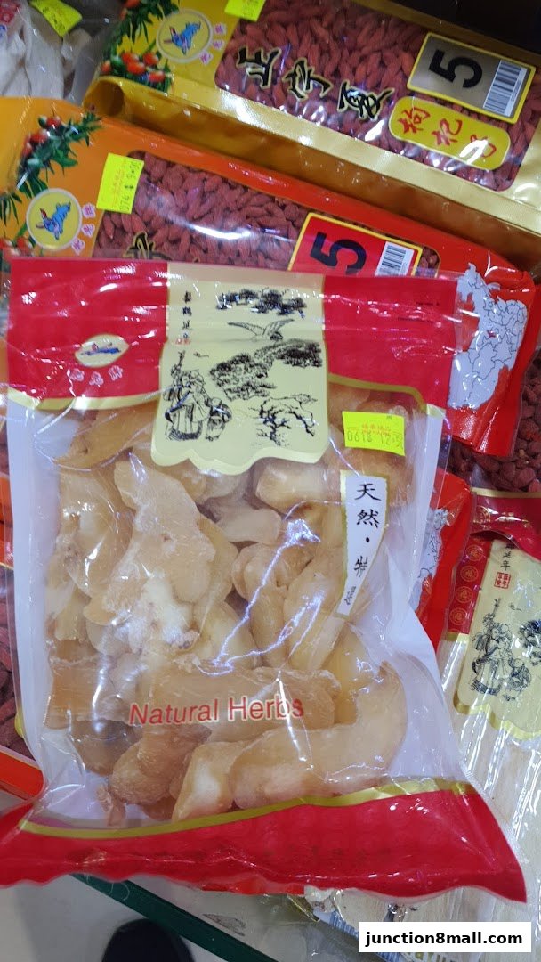 A close-up of packaged dried herbs and goji berries, with Chinese calligraphy and English labels.