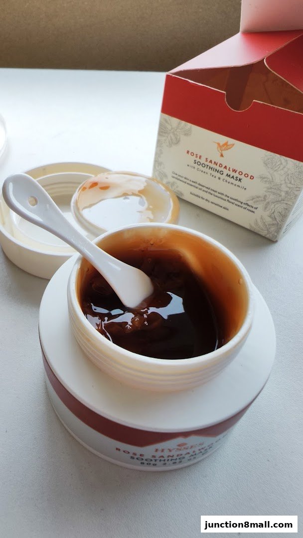 A jar of HYSSES Rose Sandalwood Soothing Mask with a spoon and its open box.