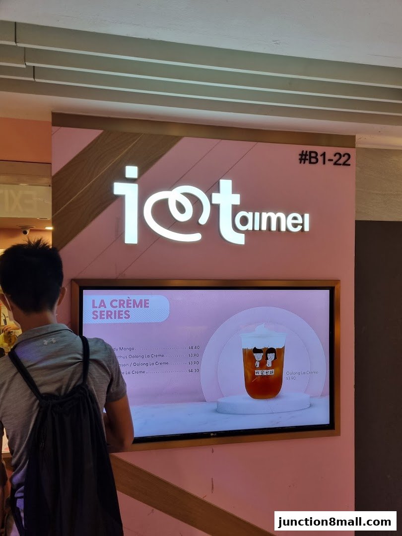 A person looks at a digital menu displaying bubble tea options at the I Love Taimei shop.