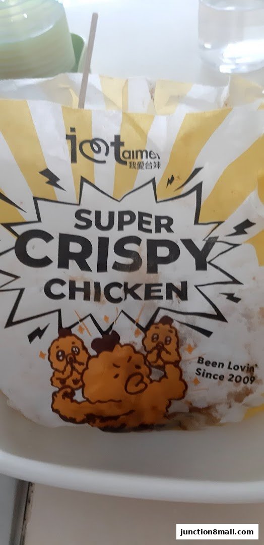 A paper bag with 'I Love Taimei' branding, advertising 'Super Crispy Chicken'.