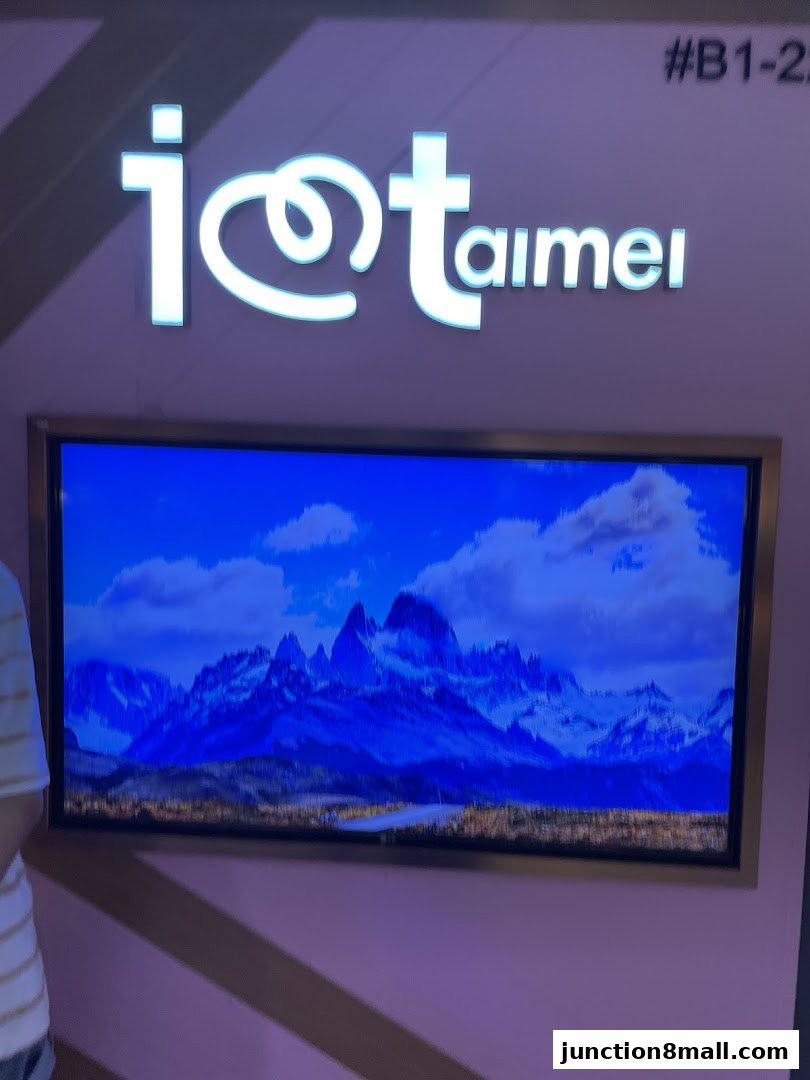 A shop sign with the name 'I Love Taimei' above a screen displaying a mountain landscape.