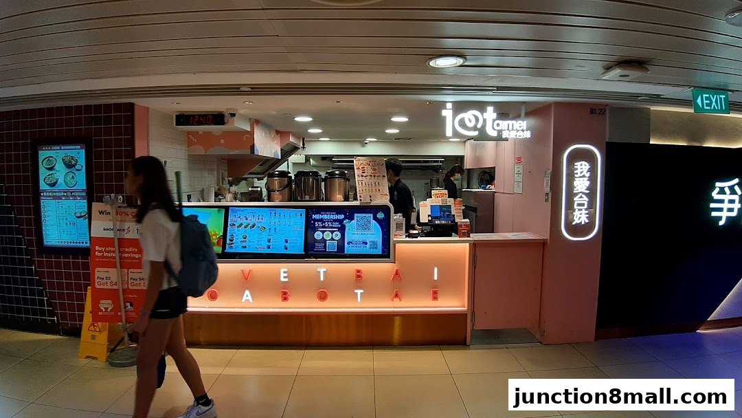 A brightly lit shop front for 'I Love Taimei' selling fried chicken and bubble tea.