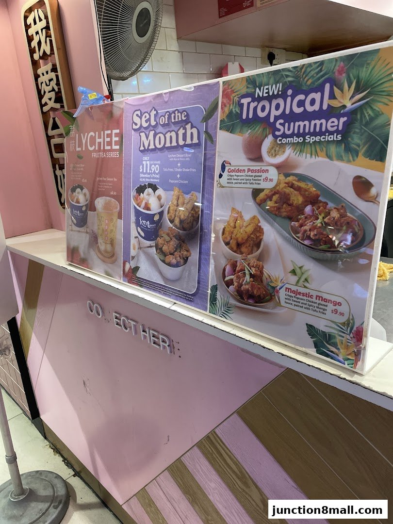 A display of promotional posters for fried chicken and bubble tea combo specials.