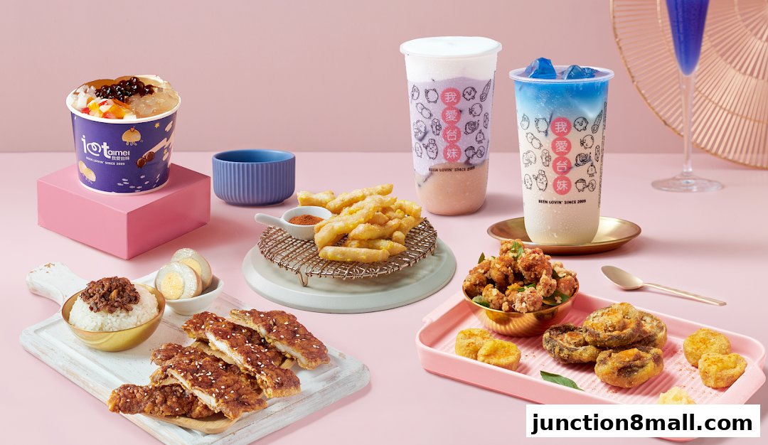 A spread of Taiwanese street food including fried chicken, bubble tea, and rice dishes.