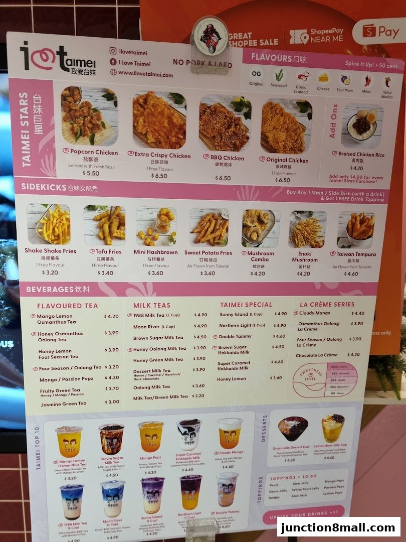 A menu board displaying various fried chicken, side dishes, milk teas, and desserts with prices.