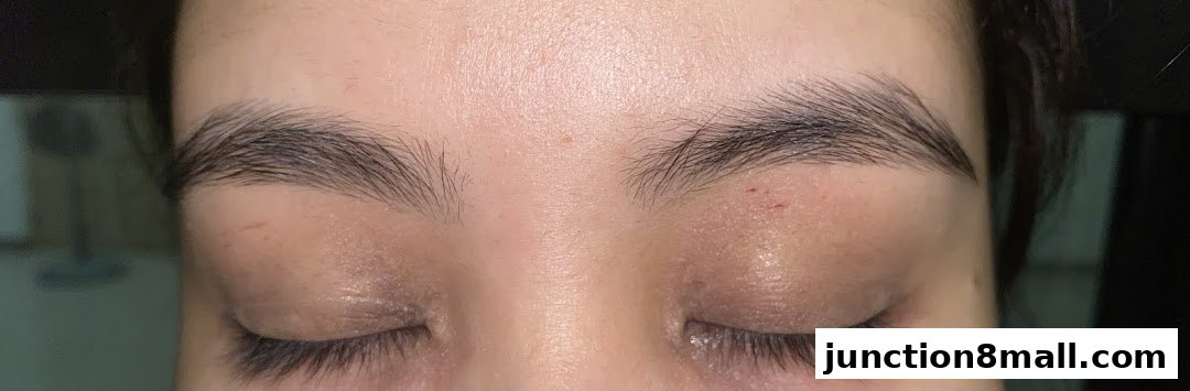 Close-up of a person's closed eyes and eyebrows, showcasing groomed eyebrows.