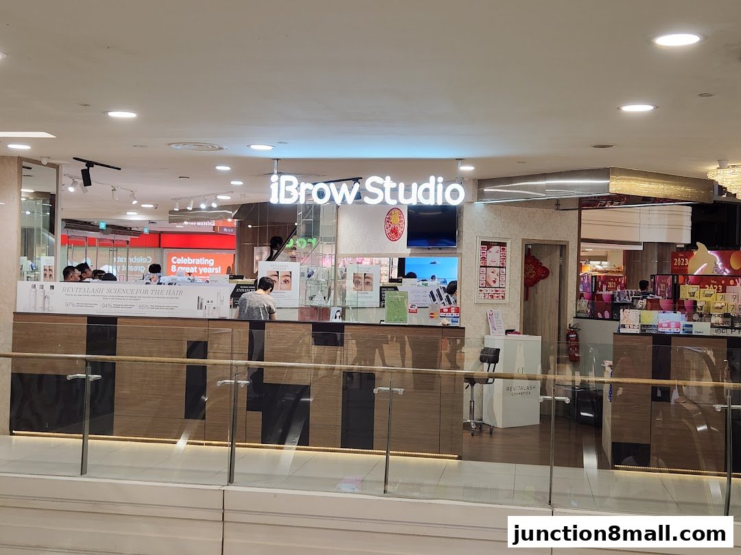 The exterior of iBrow Studio, a beauty salon, with a counter and displays.