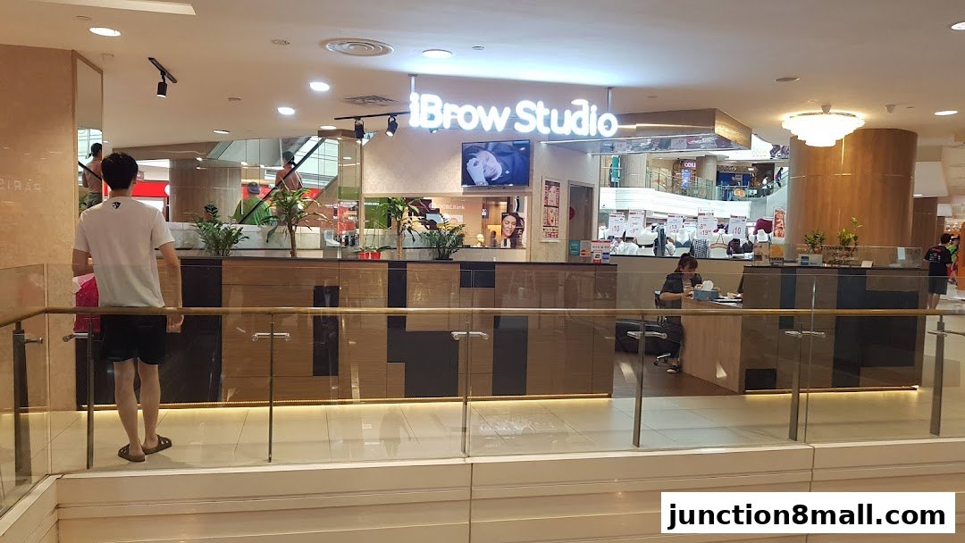 The iBrow Studio shop front with a modern design and a person standing in front.