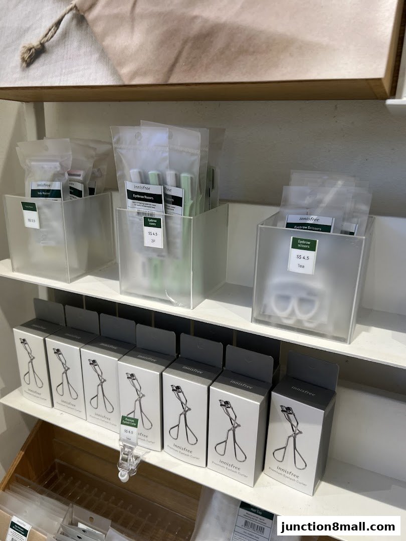 Innisfree shop display featuring eyebrow tools and eyelash curlers.