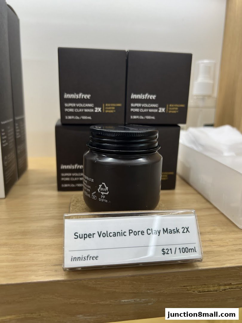 Innisfree Super Volcanic Pore Clay Mask 2X displayed on a wooden shelf with product boxes.