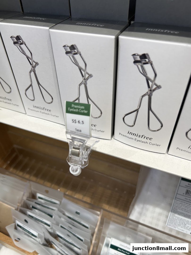 Innisfree Premium Eyelash Curlers displayed on a shelf with price tags.