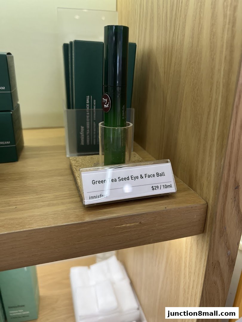 Innisfree Green Tea Seed Eye & Face Ball product displayed on a wooden shelf with pricing.
