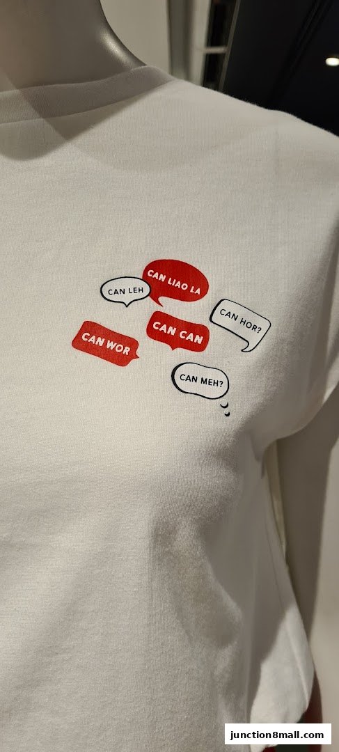 A white t-shirt with various phrases in speech bubbles printed on it.