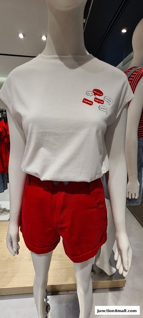 Mannequin wearing a white t-shirt with text graphics and red shorts.