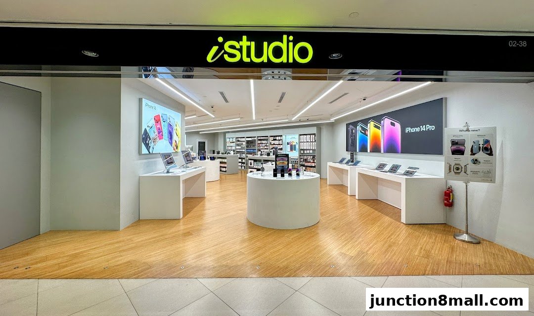 Interior view of an iStudio electronics store showcasing Apple products and displays.
