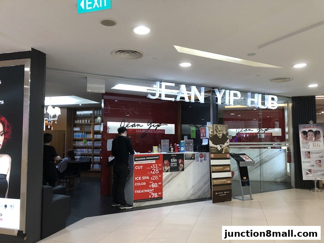 The exterior of Jean Yip Hairdressing, a salon with a prominent sign and promotional displays.