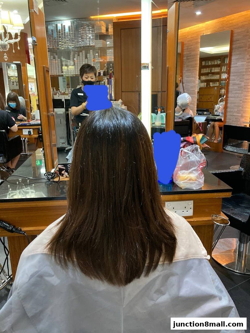 A person receiving a haircut at Jean Yip Hairdressing Junction 8.