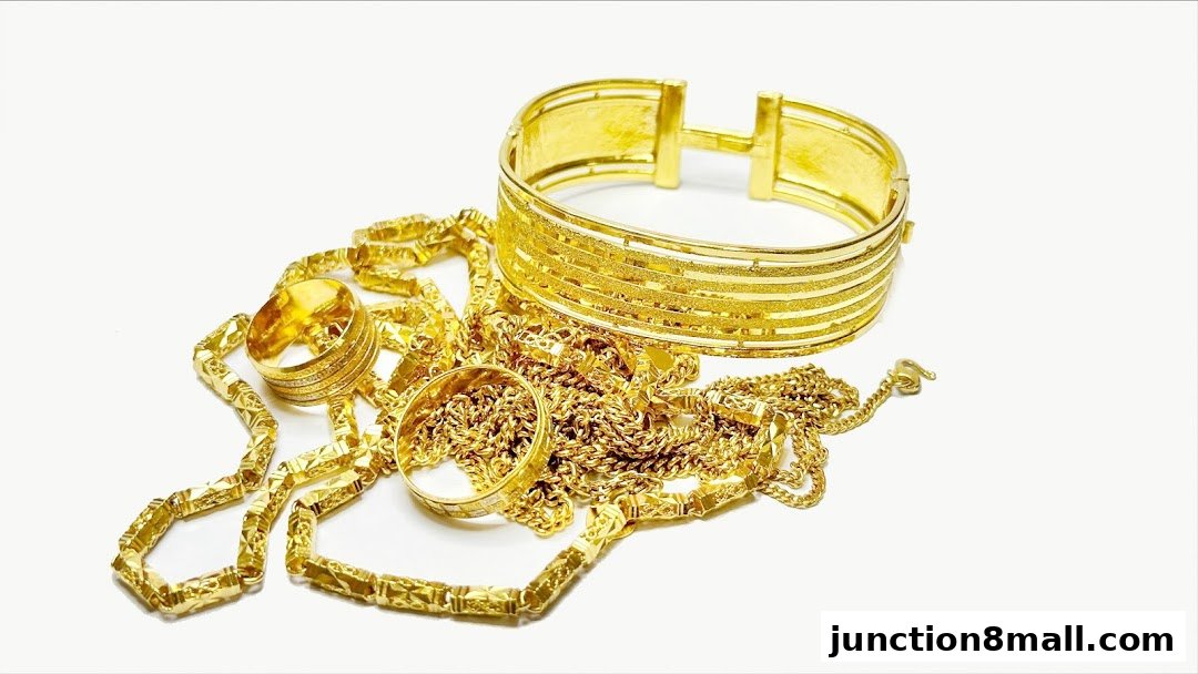 A collection of exquisite gold jewelry, including rings, a bracelet, and necklaces, displayed on a white background.