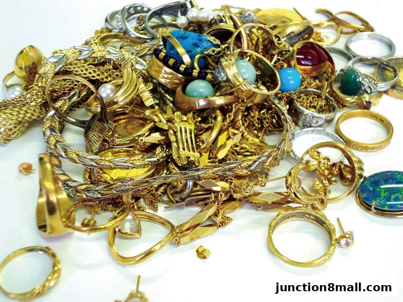 A large pile of assorted gold and silver jewelry, including rings, necklaces, and bracelets.