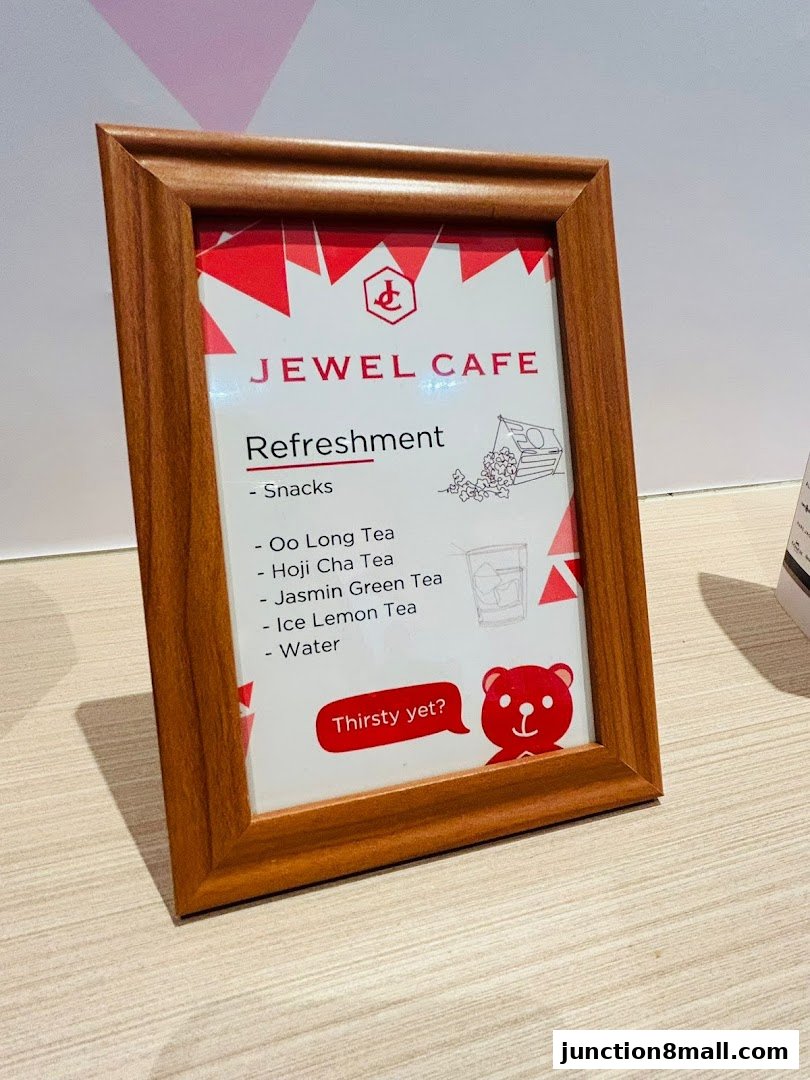 A framed menu from Jewel Cafe listing refreshments like teas and snacks.