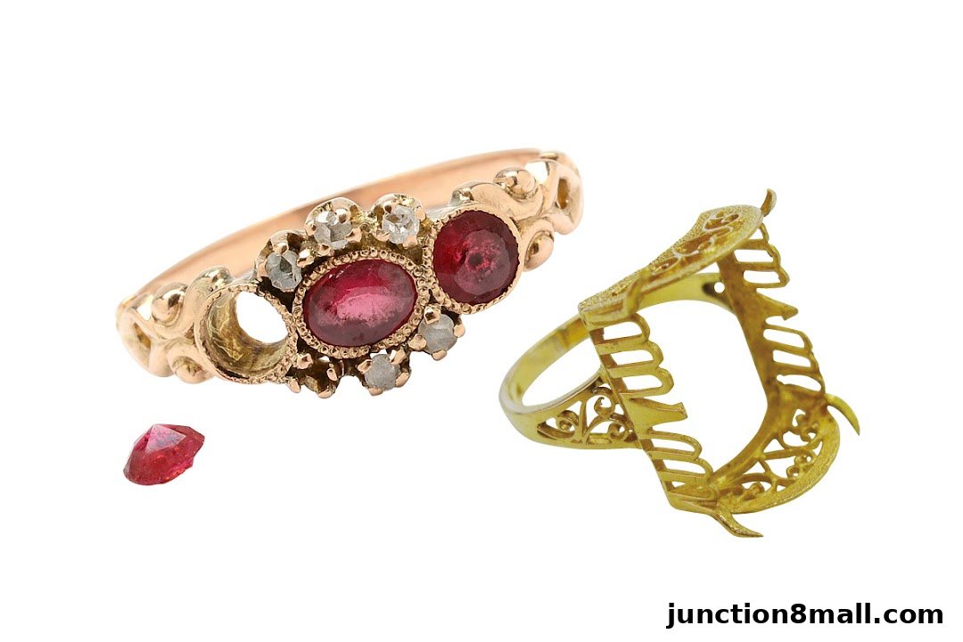 A gold ring with rubies and diamonds, and a separate gold ring setting.