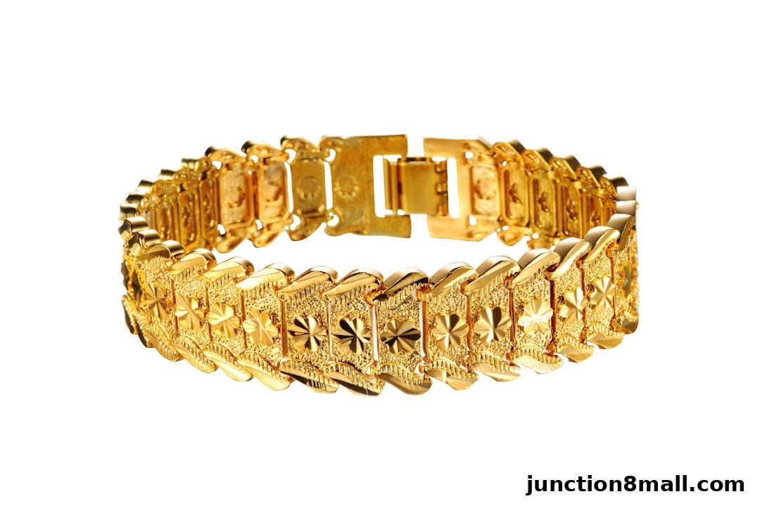 A close-up shot of a detailed, ornate gold bracelet with a white background.