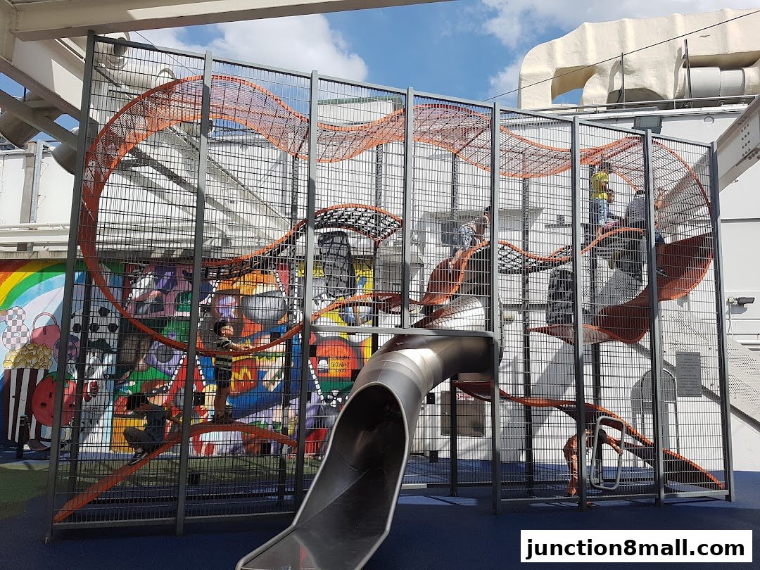 A colorful indoor playground with slides and climbing structures for children.