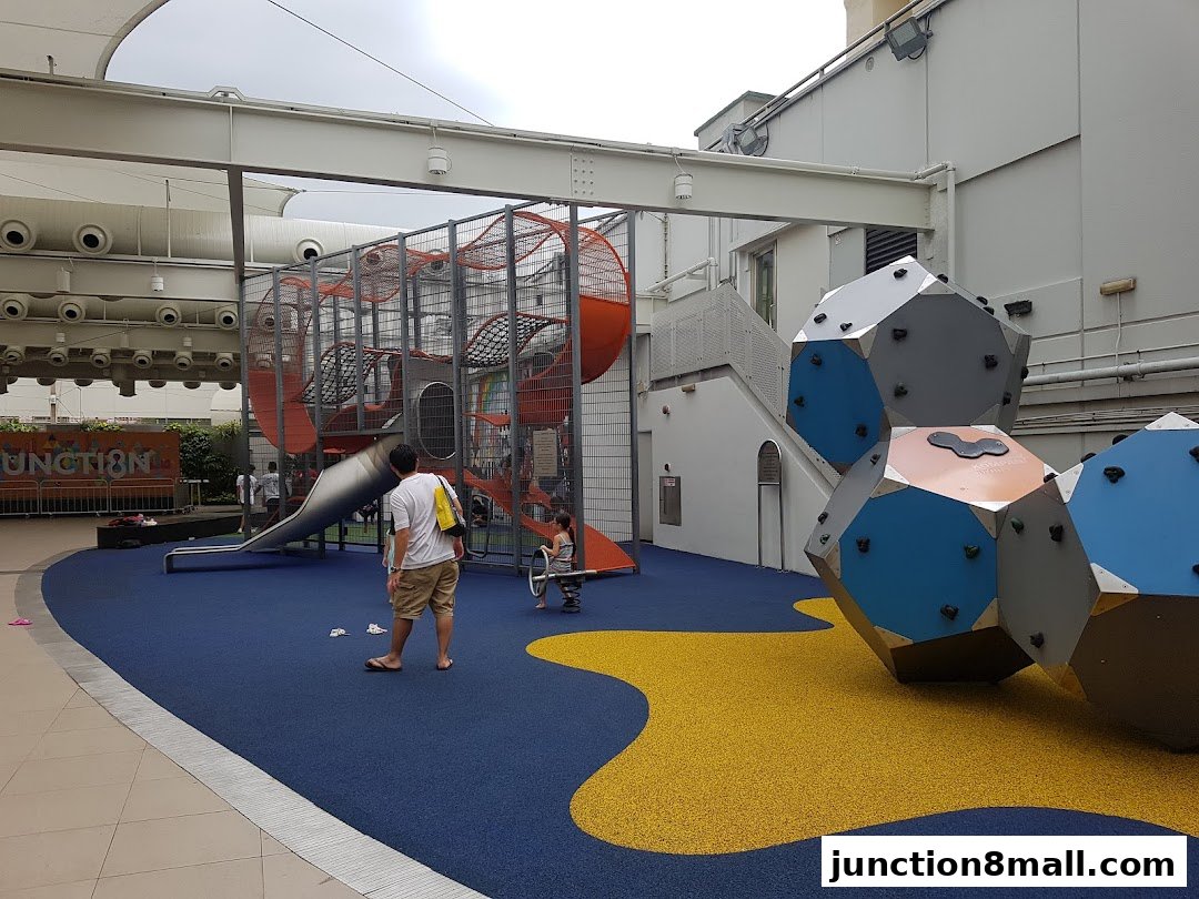 A colorful playground with climbing structures and slides for children.