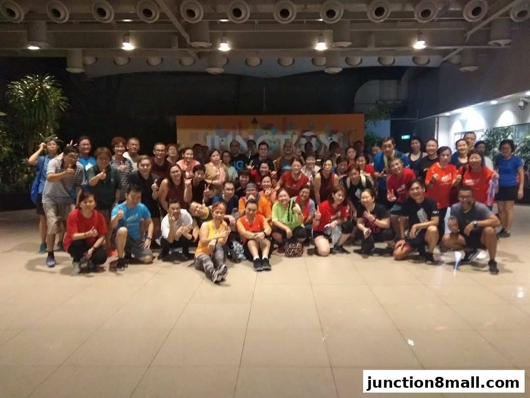 A large group of people, mostly adults, posing for a photo in an indoor setting.