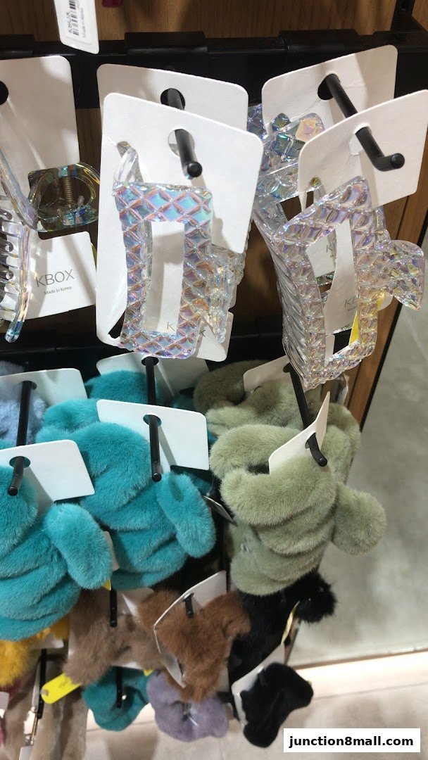 A display of colorful and sparkly hair accessories, including claw clips and scrunchies.