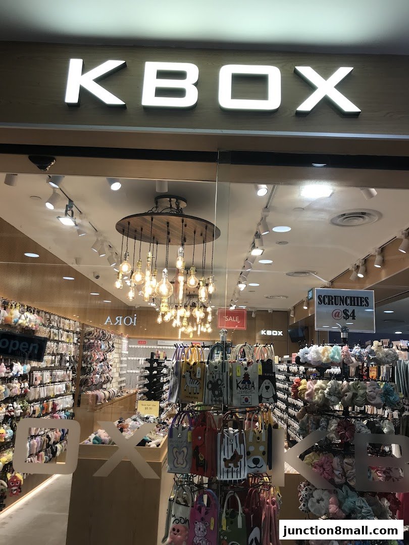 The KBOX shop front displays a wide variety of accessories, including bags and scrunchies.