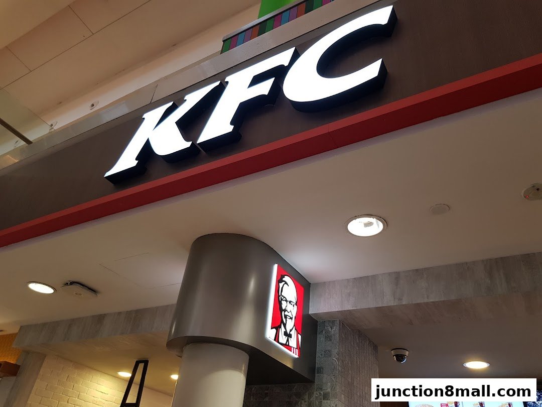 The iconic KFC logo and Colonel Sanders are displayed prominently above the shop entrance.