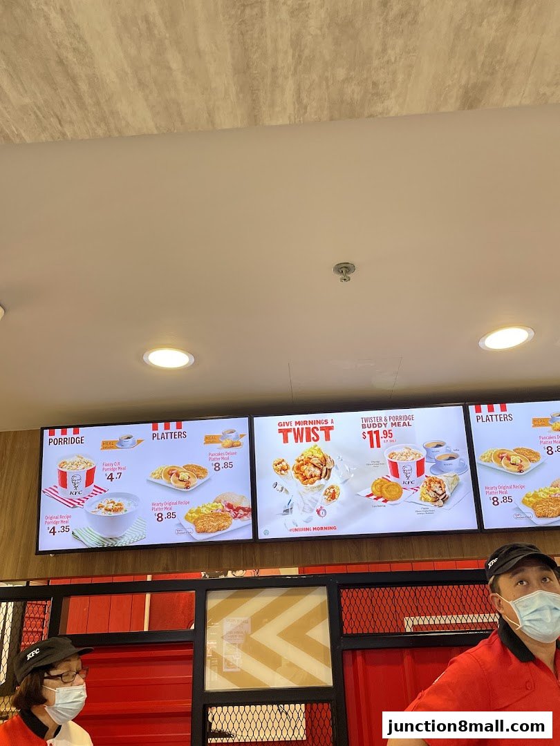 KFC menu board displaying breakfast items like porridge and platters.