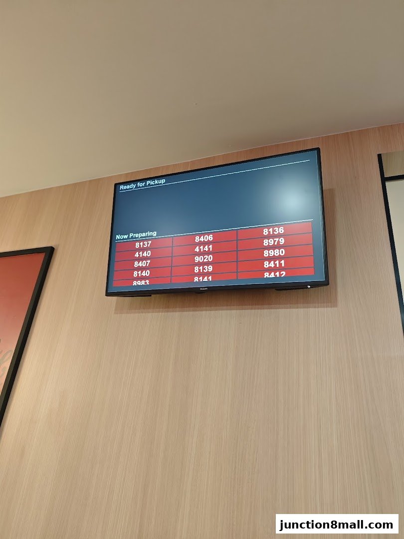 A digital screen displays order numbers that are currently being prepared or are ready for pickup at KFC.