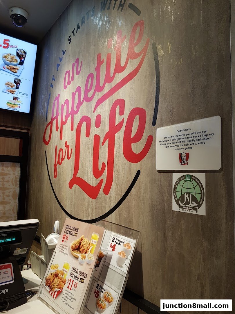 KFC restaurant interior with a large wall graphic and menu displays.