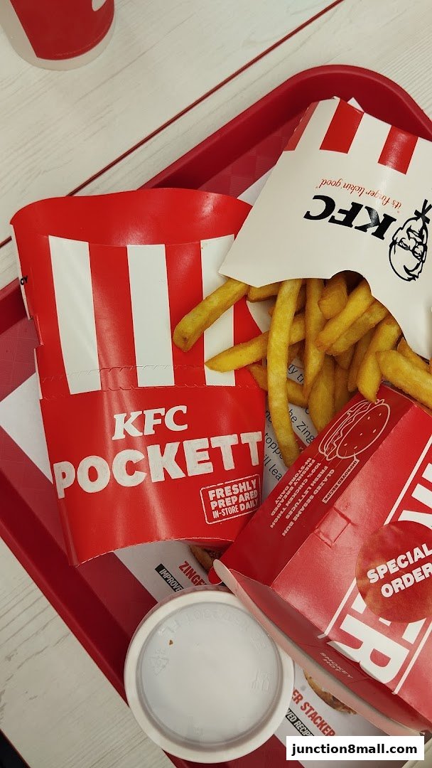 A tray of KFC food including fries, a drink cup, and packaging for a Pocketts and a Stacker.