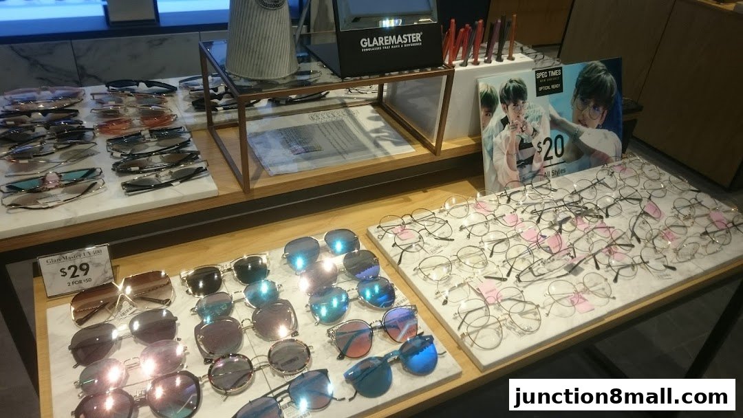 A display of various sunglasses and eyeglasses, with a promotional poster featuring a celebrity.