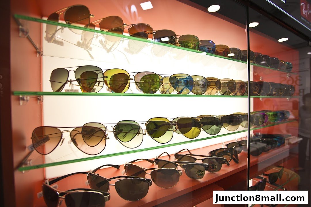 A display case filled with various styles of sunglasses on shelves.
