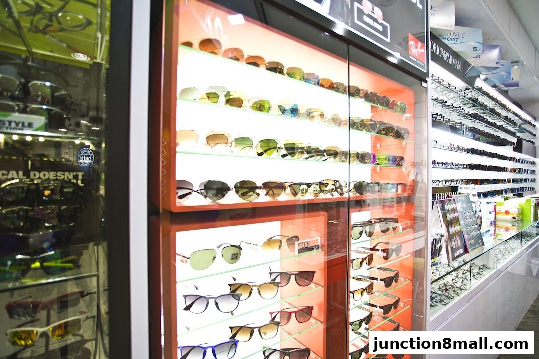 A well-lit display of sunglasses and eyeglasses in a retail store.